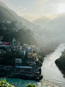 Scenic aerial view of Devprayag where rivers meet, surrounded by mountains.